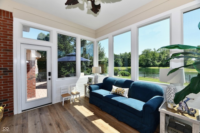7413 Misty Woods Ln, Indianapolis, IN 46237 - sunroom featuring wood finished floors, plenty of natural light, and a deck with water view