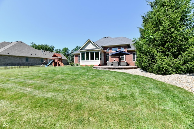 7413 Misty Woods Ln, Indianapolis, IN 46237 - back of property featuring a playground, a patio, and brick siding