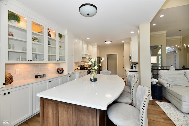 7413 Misty Woods Ln, Indianapolis, IN 46237 - kitchen with open floor plan, wood finished floors, white cabinetry, backsplash, and light countertops