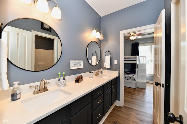 7413 Misty Woods Ln, Indianapolis, IN 46237 - full bathroom featuring double vanity, wood finished floors, ceiling fan, and connected bathroom