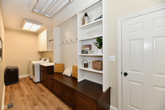 7413 Misty Woods Ln, Indianapolis, IN 46237 - washroom featuring cabinet space, light wood finished floors, and washer and dryer