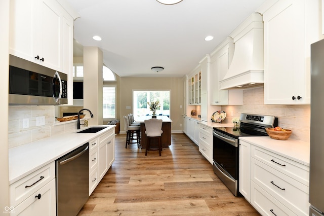 7413 Misty Woods Ln, Indianapolis, IN 46237 - kitchen with stainless steel appliances, premium range hood, backsplash, white cabinets, and recessed lighting