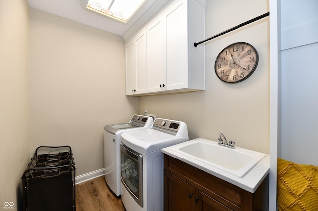 7413 Misty Woods Ln, Indianapolis, IN 46237 - washroom featuring washer and dryer, cabinet space, and wood finished floors