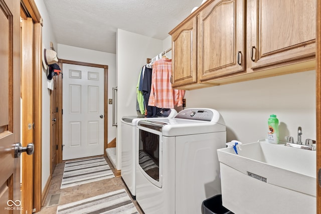 6980 White Oak Dr, Avon, IN 46123 - laundry room featuring washer and clothes dryer, cabinet space, and a textured ceiling