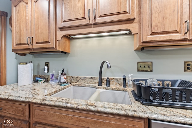 6980 White Oak Dr, Avon, IN 46123 - kitchen featuring light stone countertops, brown cabinetry, and dishwasher