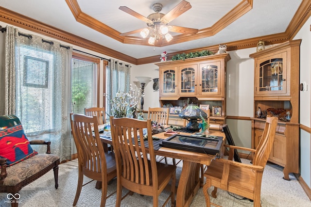 6980 White Oak Dr, Avon, IN 46123 - dining space with a raised ceiling, light carpet, crown molding, and a ceiling fan