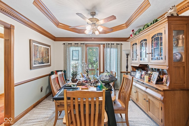 6980 White Oak Dr, Avon, IN 46123 - dining room featuring a raised ceiling, light carpet, crown molding, and a ceiling fan