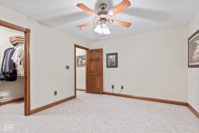 6980 White Oak Dr, Avon, IN 46123 - unfurnished bedroom with a walk in closet, carpet, a closet, and ceiling fan