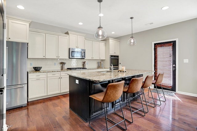 773 Bracknell Dr, Avon, IN 46123 - kitchen with stainless steel appliances, backsplash, dark wood finished floors, white cabinetry, and recessed lighting