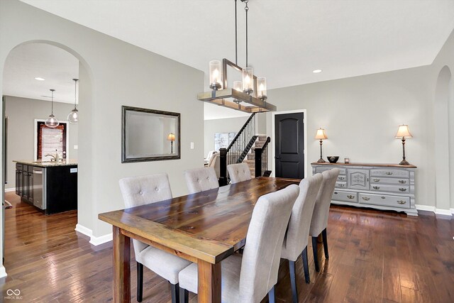773 Bracknell Dr, Avon, IN 46123 - dining space featuring arched walkways, dark wood-type flooring, recessed lighting, stairs, and a chandelier