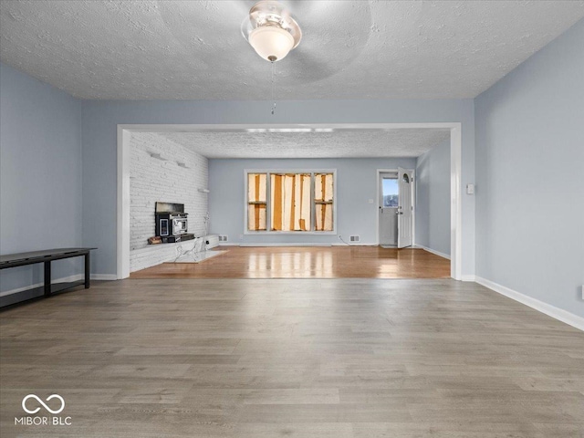 7422 E 33rd St, Indianapolis, IN 46226 - unfurnished living room with a textured ceiling and wood finished floors