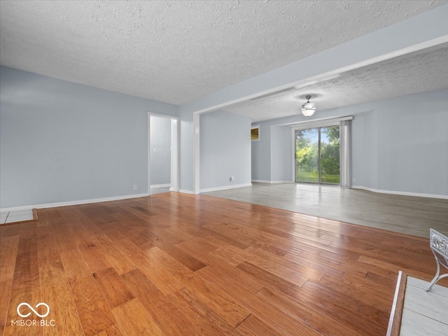 7422 E 33rd St, Indianapolis, IN 46226 - unfurnished living room with a textured ceiling and wood finished floors
