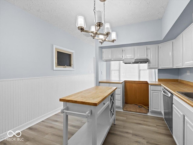 7422 E 33rd St, Indianapolis, IN 46226 - kitchen featuring a chandelier, stainless steel dishwasher, wood counters, a textured ceiling, and light wood finished floors