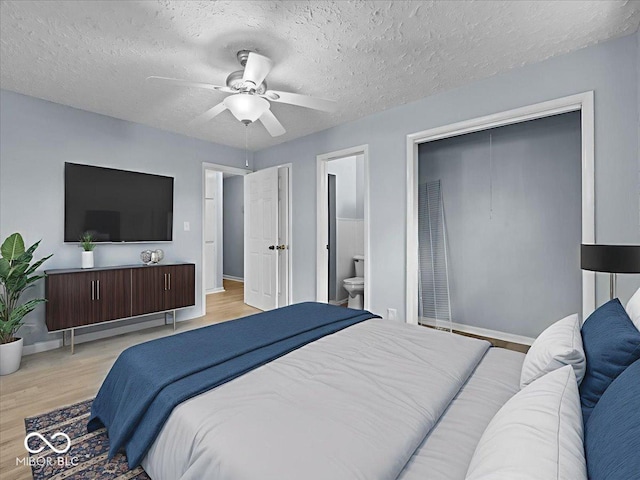 7422 E 33rd St, Indianapolis, IN 46226 - bedroom featuring light wood-style flooring, a ceiling fan, ensuite bathroom, and a textured ceiling