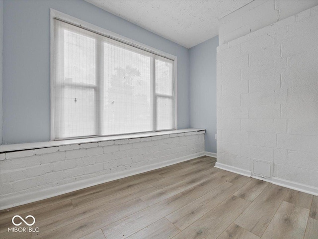 7422 E 33rd St, Indianapolis, IN 46226 - unfurnished room with wood finished floors and a textured ceiling
