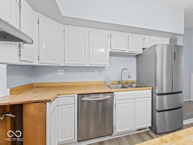 7422 E 33rd St, Indianapolis, IN 46226 - kitchen featuring appliances with stainless steel finishes, under cabinet range hood, white cabinets, and light countertops