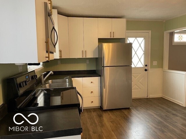 kitchen with freestanding refrigerator, electric stove, dark countertops, black microwave, and ornamental molding