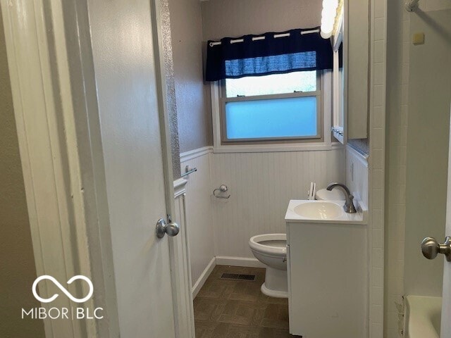 bathroom with a wainscoted wall and vanity