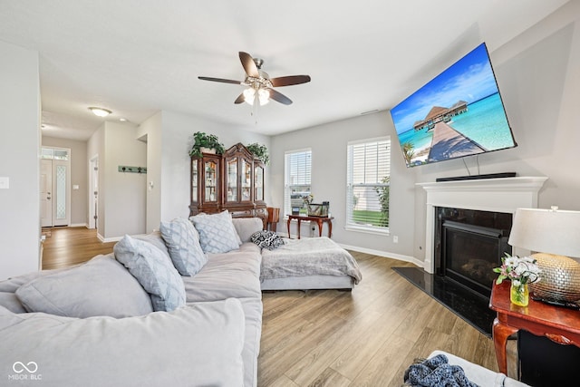 8126 Kilborn Way, Avon, IN 46123 - living area featuring wood finished floors, ceiling fan, and a high end fireplace