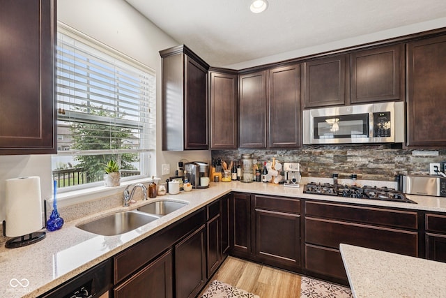 8126 Kilborn Way, Avon, IN 46123 - kitchen featuring stainless steel microwave, gas cooktop, dark brown cabinets, light stone counters, and recessed lighting
