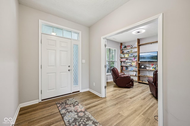 8126 Kilborn Way, Avon, IN 46123 - foyer entrance with wood finished floors and a textured ceiling