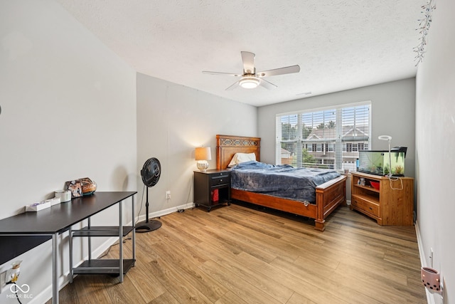 8126 Kilborn Way, Avon, IN 46123 - bedroom with light wood finished floors, a textured ceiling, and ceiling fan