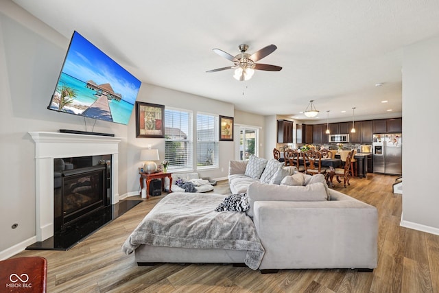 8126 Kilborn Way, Avon, IN 46123 - living room featuring light wood-type flooring, a ceiling fan, a premium fireplace, and recessed lighting