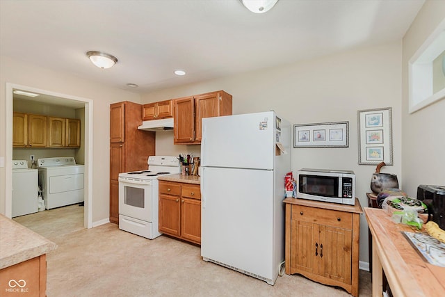 4218 E 18th St, Indianapolis, IN 46218 - kitchen featuring white appliances, under cabinet range hood, independent washer and dryer, light countertops, and recessed lighting