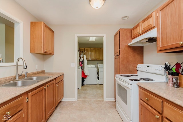 4218 E 18th St, Indianapolis, IN 46218 - kitchen featuring white range with electric cooktop, under cabinet range hood, separate washer and dryer, and light countertops