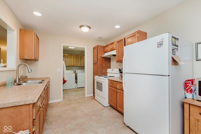 4218 E 18th St, Indianapolis, IN 46218 - kitchen featuring white appliances, washer and dryer, under cabinet range hood, light countertops, and light colored carpet