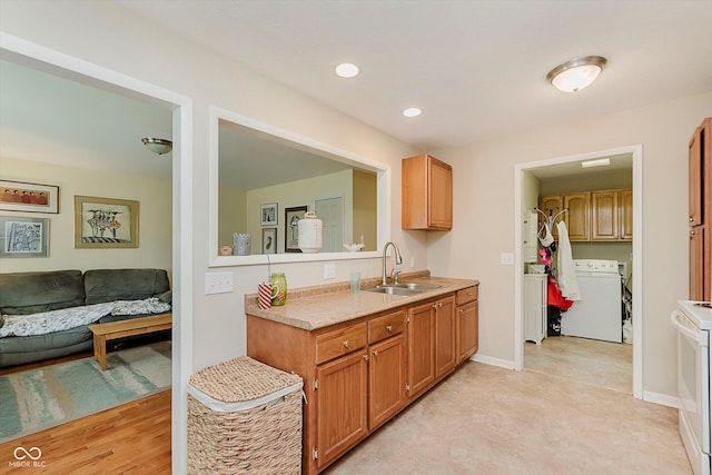 4218 E 18th St, Indianapolis, IN 46218 - kitchen featuring washer / dryer, light countertops, white range, brown cabinetry, and recessed lighting