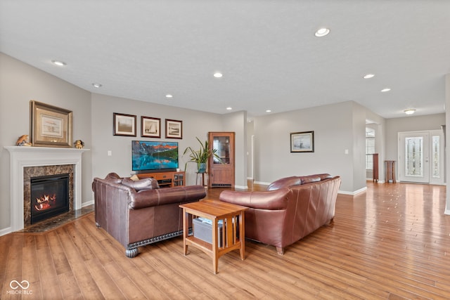 4434 Hickory Ridge Blvd, Greenwood, IN 46143 - living room featuring light wood-type flooring, a premium fireplace, and recessed lighting