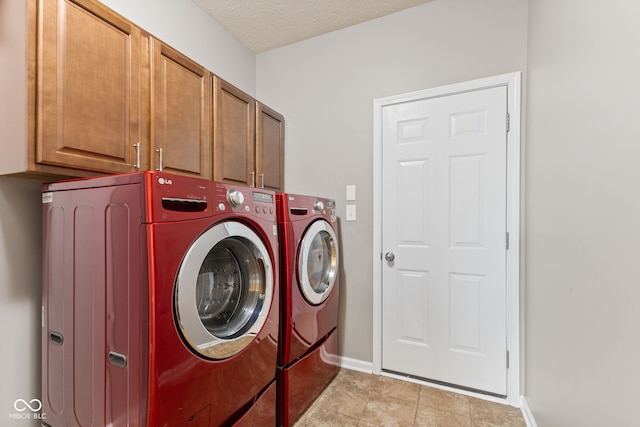 4434 Hickory Ridge Blvd, Greenwood, IN 46143 - washroom with cabinet space, washing machine and dryer, a textured ceiling, and light tile patterned floors