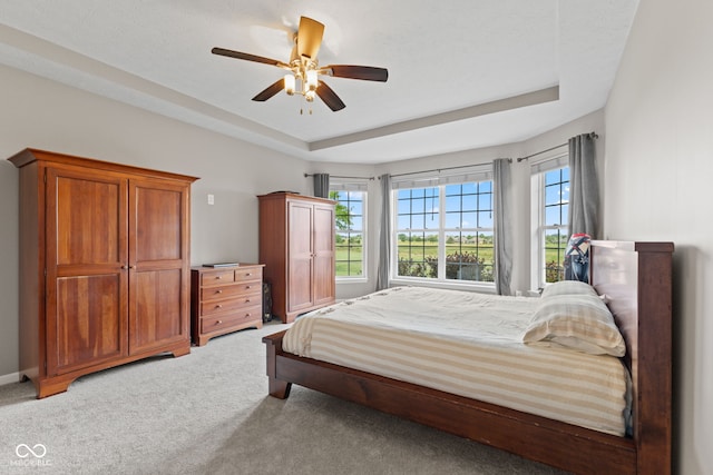 4434 Hickory Ridge Blvd, Greenwood, IN 46143 - bedroom featuring light carpet, a tray ceiling, and ceiling fan