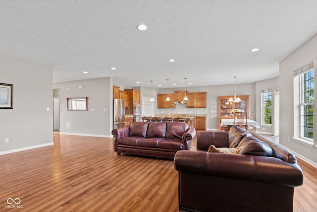 4434 Hickory Ridge Blvd, Greenwood, IN 46143 - living room featuring light wood finished floors, recessed lighting, a chandelier, and a textured ceiling