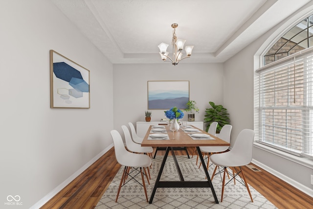 4434 Hickory Ridge Blvd, Greenwood, IN 46143 - dining space featuring a chandelier, a tray ceiling, and wood finished floors
