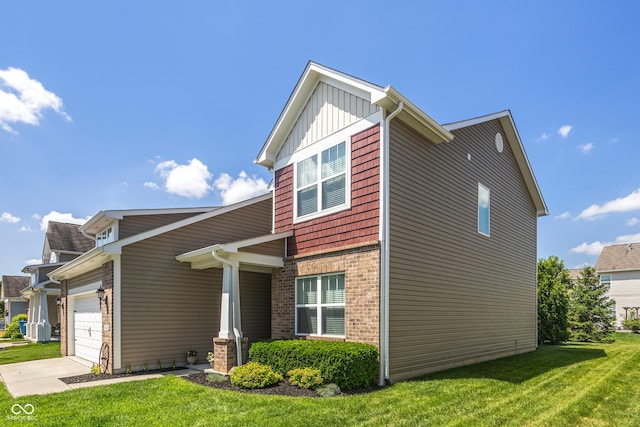 13992 Wynngate Ln, Fishers, IN 46038 - view of side of property with a lawn, an attached garage, concrete driveway, brick siding, and board and batten siding