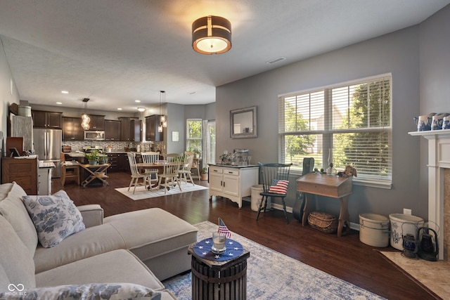 13992 Wynngate Ln, Fishers, IN 46038 - living room with dark wood-type flooring, a fireplace with flush hearth, and recessed lighting