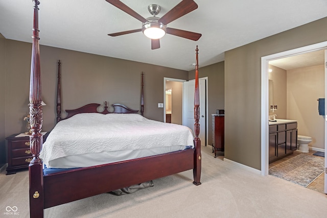 13992 Wynngate Ln, Fishers, IN 46038 - bedroom with light carpet, connected bathroom, and a ceiling fan