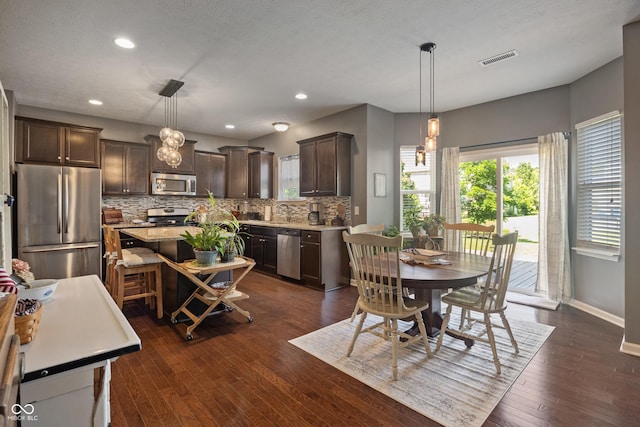 13992 Wynngate Ln, Fishers, IN 46038 - dining space with dark wood-type flooring and recessed lighting