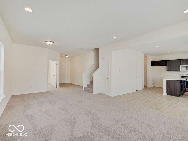 1006 E Brandy Blvd E, Ellettsville, IN 47429 - unfurnished living room featuring stairs, recessed lighting, and light colored carpet