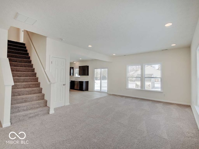 1006 E Brandy Blvd E, Ellettsville, IN 47429 - unfurnished living room featuring light colored carpet, stairs, and recessed lighting
