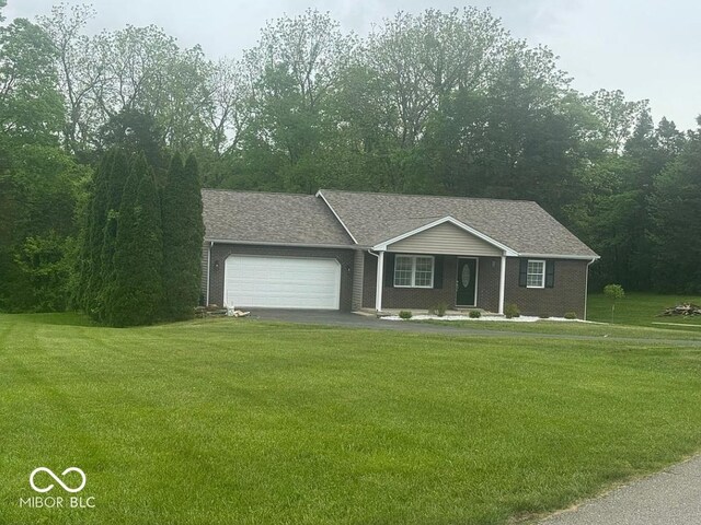 935 S County Road 185 E, North Vernon, IN 47265 - ranch-style house featuring an attached garage, a front yard, asphalt driveway, and roof with shingles