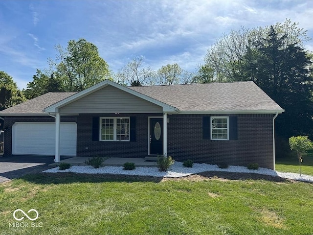935 S County Road 185 E, North Vernon, IN 47265 - ranch-style house with brick siding, a garage, a front yard, and asphalt driveway