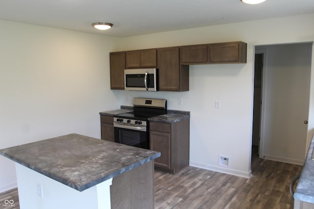 1029 E Brandy Blvd E, Ellettsville, IN 47429 - kitchen with appliances with stainless steel finishes, dark countertops, and dark wood finished floors
