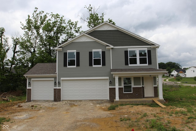 1029 E Brandy Blvd E, Ellettsville, IN 47429 - view of front of house featuring brick siding, driveway, a porch, and a garage