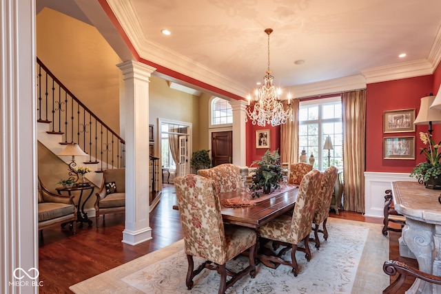 4636 S Hawks Way, Bloomington, IN 47401 - dining area featuring ornate columns, ornamental molding, a chandelier, dark wood-style flooring, and a wainscoted wall