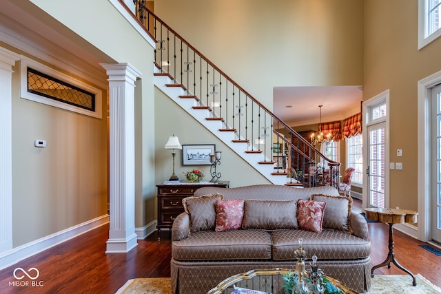 4636 S Hawks Way, Bloomington, IN 47401 - living room with a high ceiling, ornate columns, wood finished floors, and a chandelier