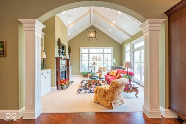 4636 S Hawks Way, Bloomington, IN 47401 - living room featuring decorative columns, arched walkways, healthy amount of natural light, beamed ceiling, and wood finished floors