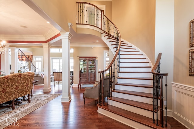 4636 S Hawks Way, Bloomington, IN 47401 - foyer featuring ornate columns, stairway, crown molding, a high ceiling, and wood finished floors